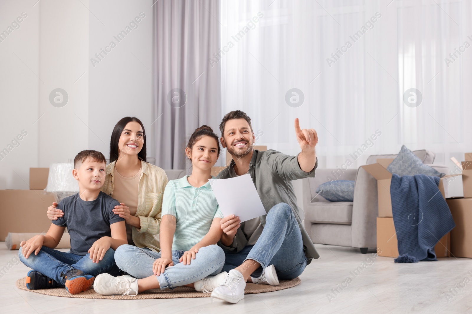 Photo of Happy family spending time in new apartment. Moving day