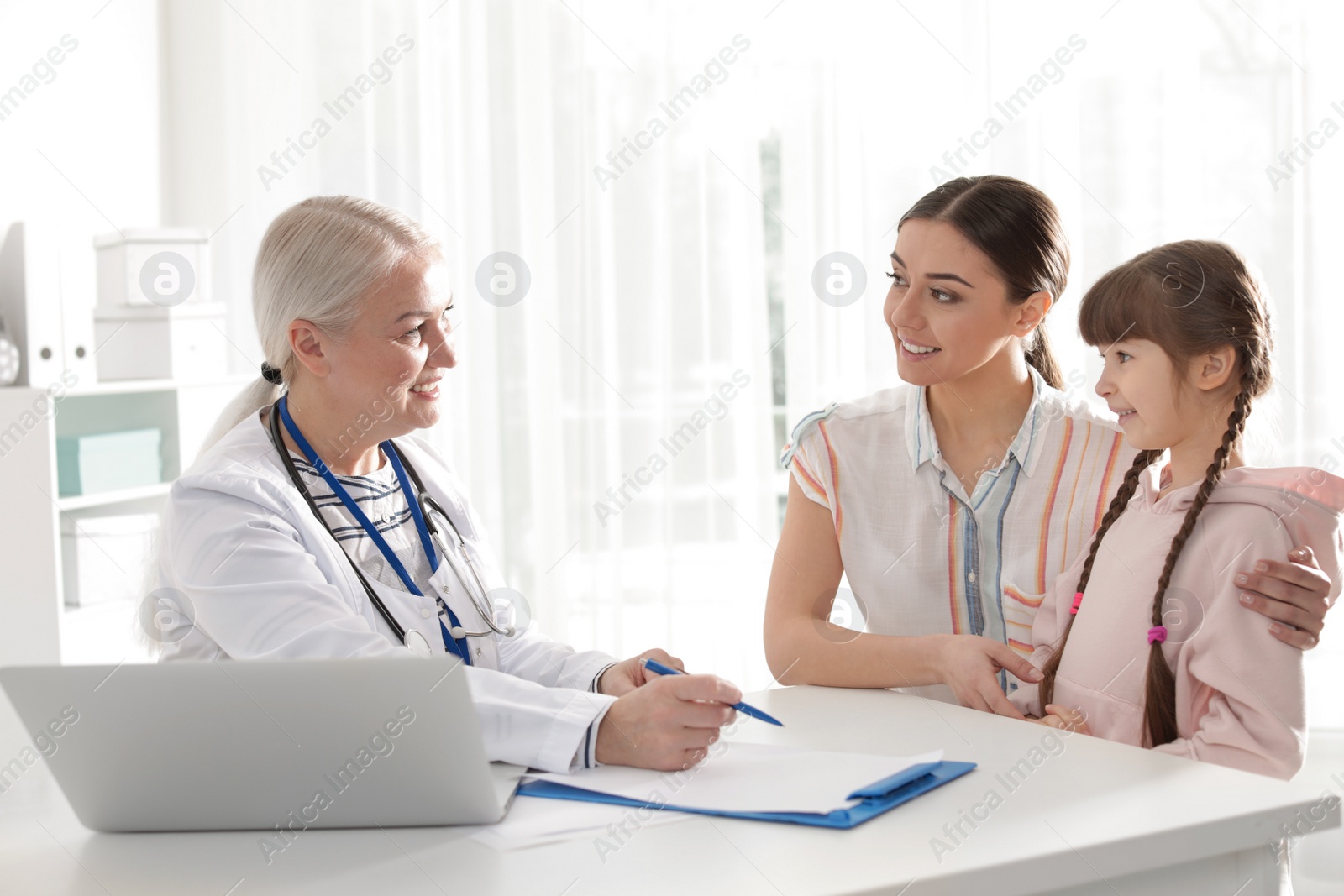 Photo of Mother with child visiting doctor in hospital