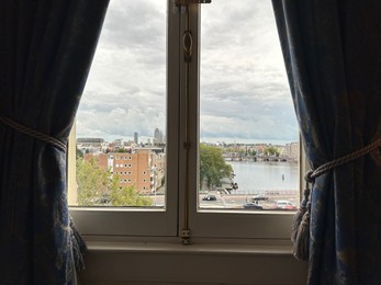 Photo of Amterdam, Netherlands - September 22, 2023: Beautiful view on city through Amstel Hotel window