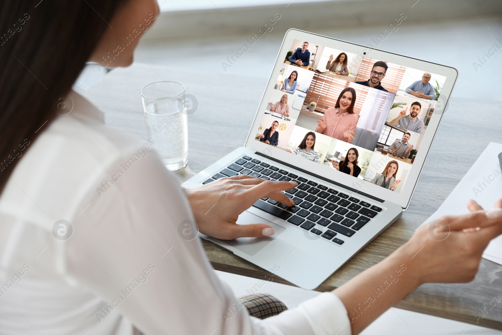 Image of Woman having video chat with team at table, closeup