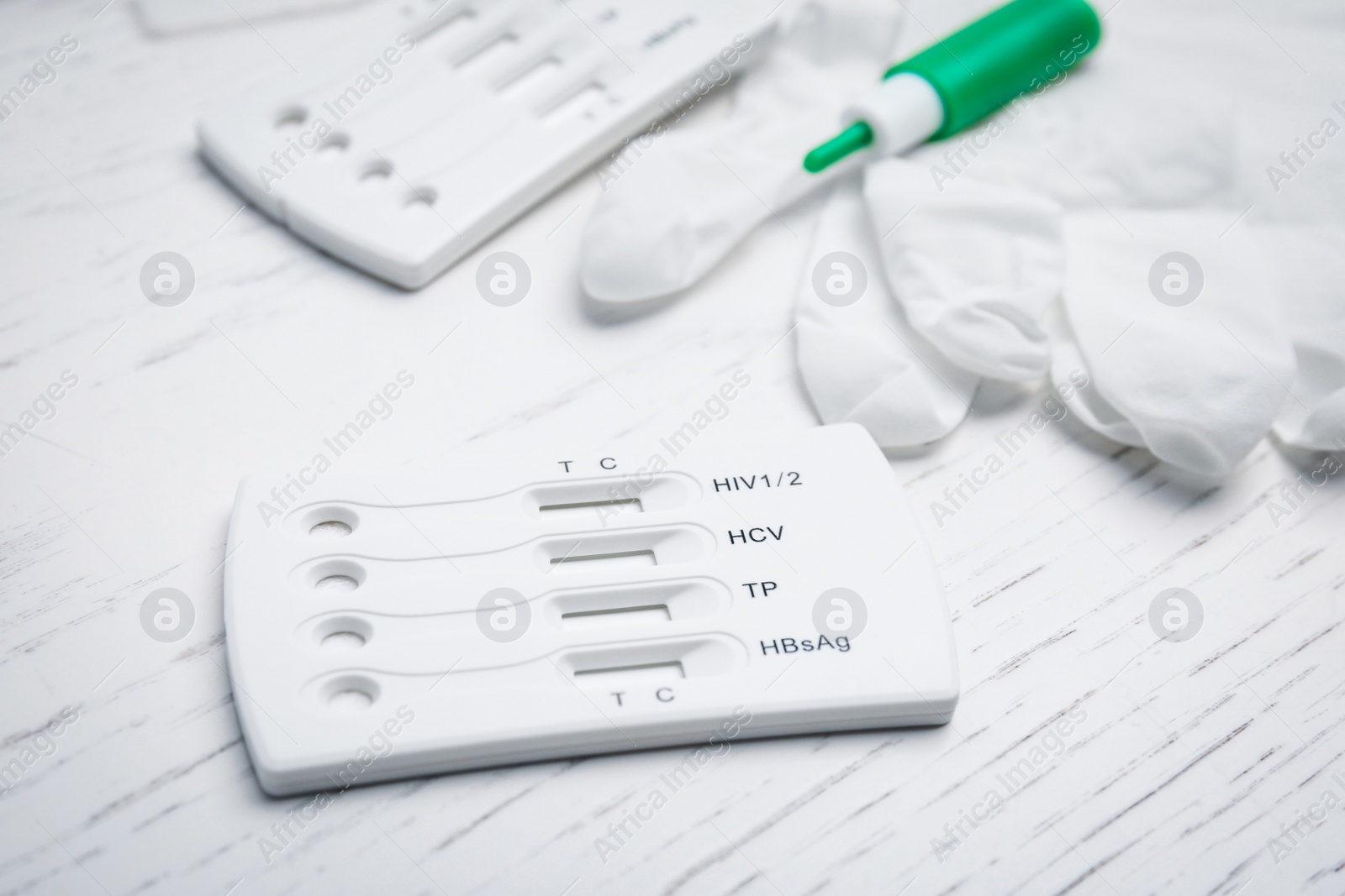 Photo of Disposable express test kit for hepatitis on white wooden table