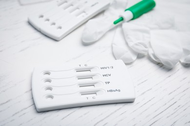 Photo of Disposable express test kit for hepatitis on white wooden table