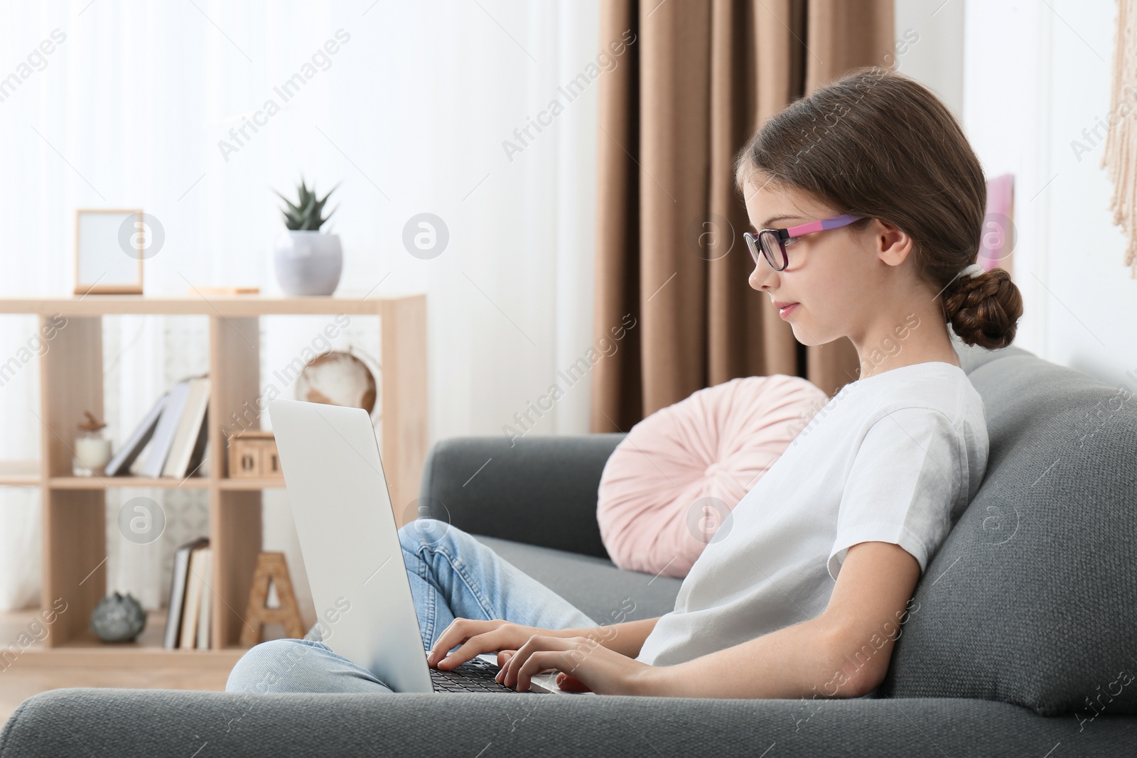 Photo of Girl with laptop on sofa at home