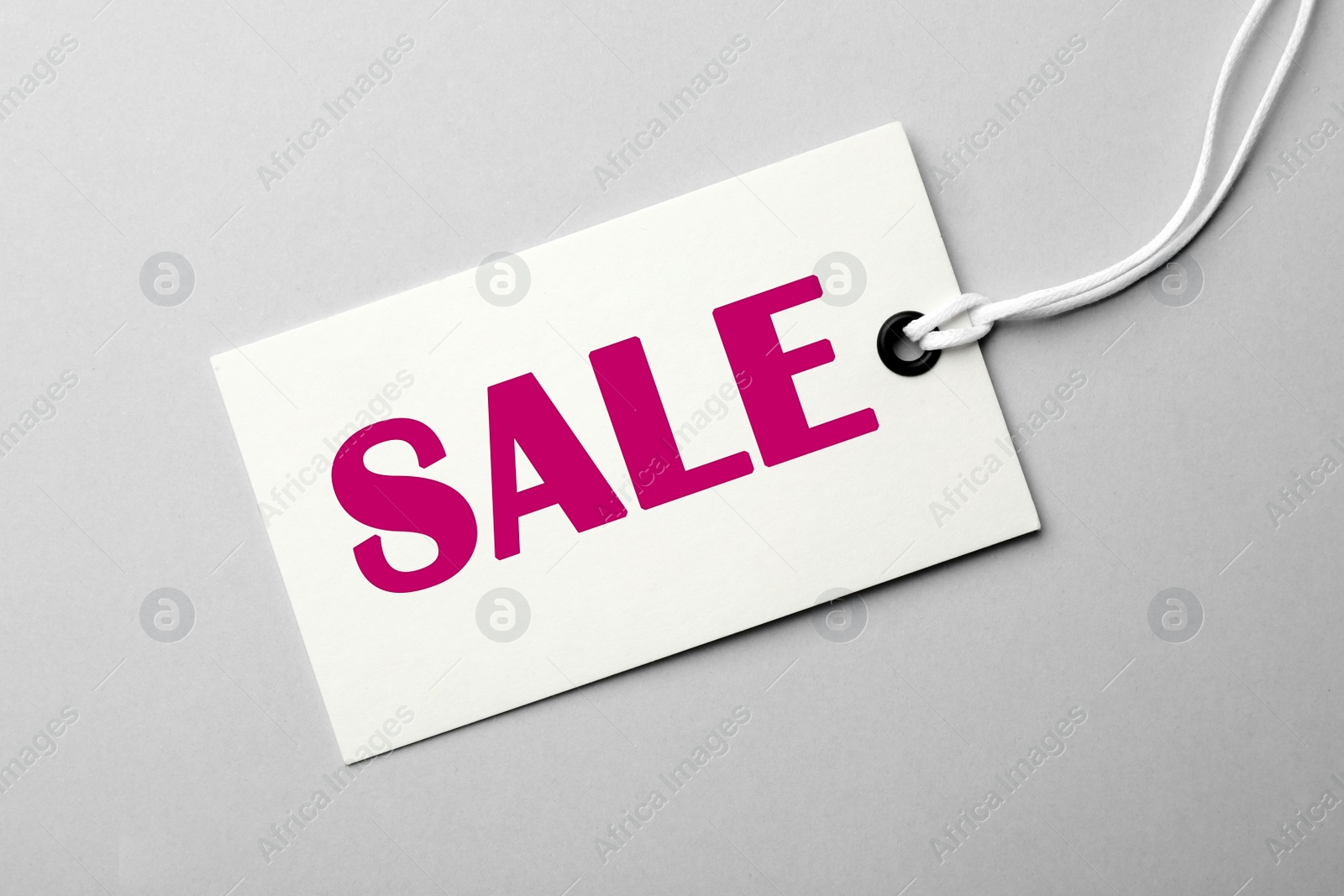 Image of Tag with text SALE on light background, top view. Black Friday 