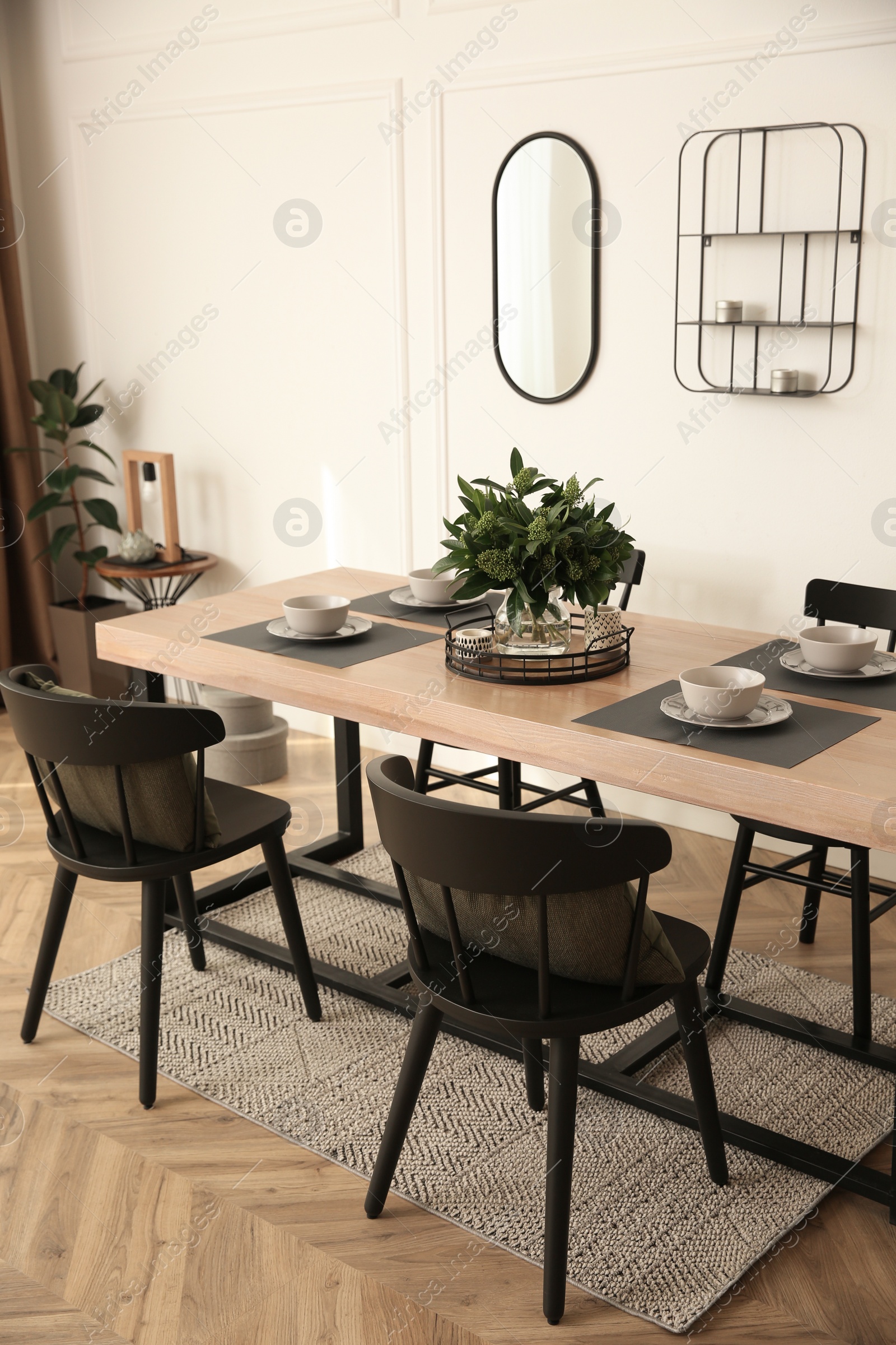 Photo of Stylish wooden dining table and chairs in room. Interior design