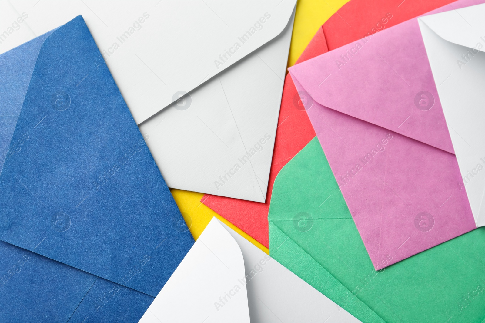 Photo of Colorful paper envelopes as background, top view