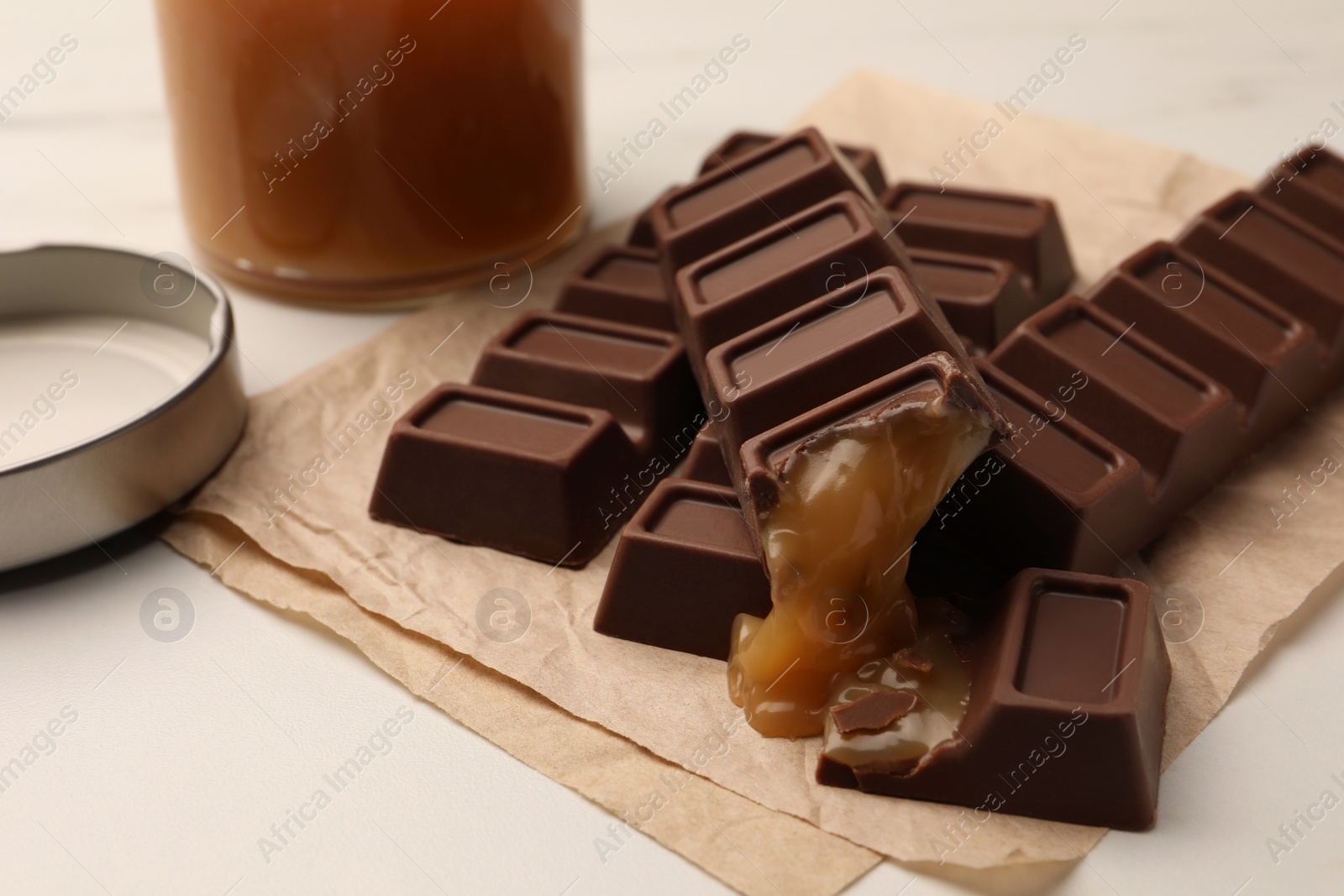 Photo of Tasty sweet chocolate bars on white table