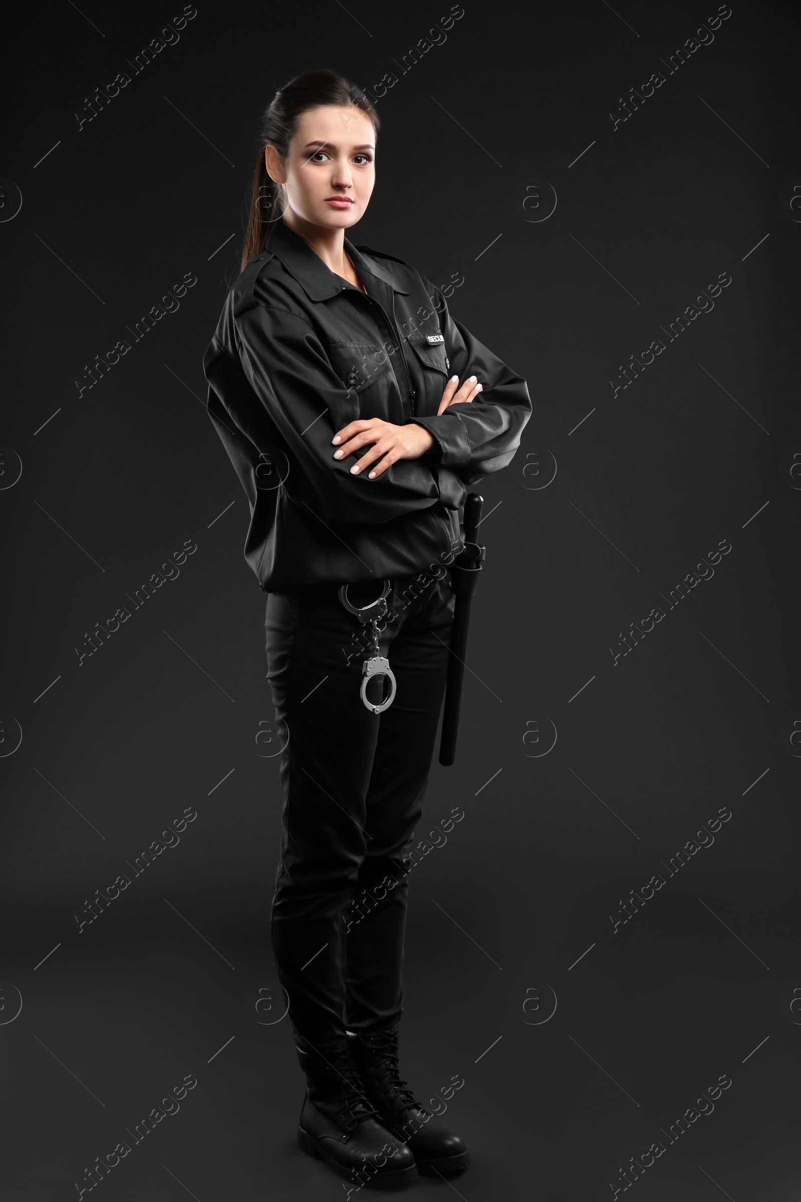 Photo of Female security guard in uniform on dark background