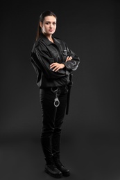 Female security guard in uniform on dark background