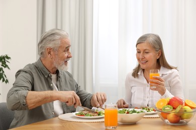 Photo of Happy senior couple having dinner at home