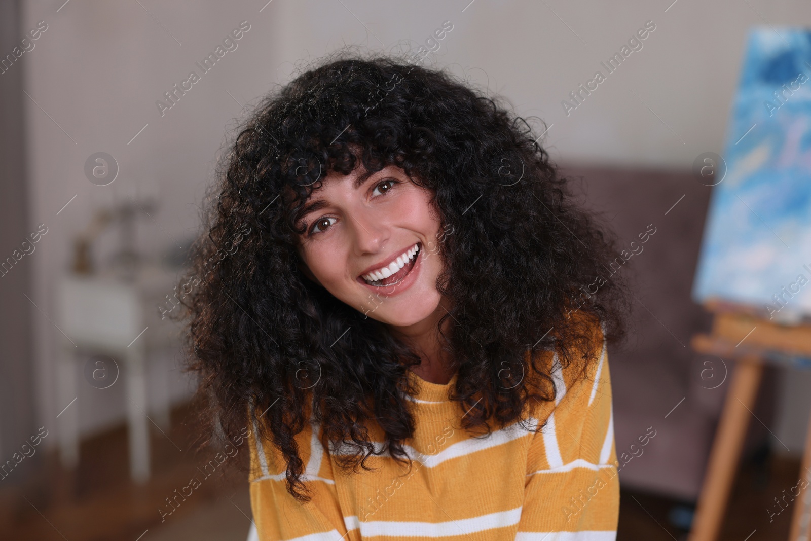 Photo of Portrait of happy young woman in stylish sweater indoors