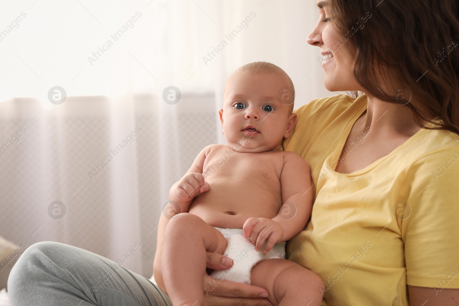 Photo of Happy young mother with her cute baby at home