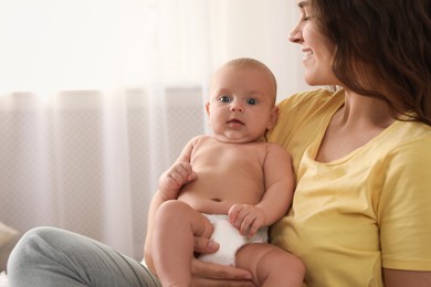 Happy young mother with her cute baby at home