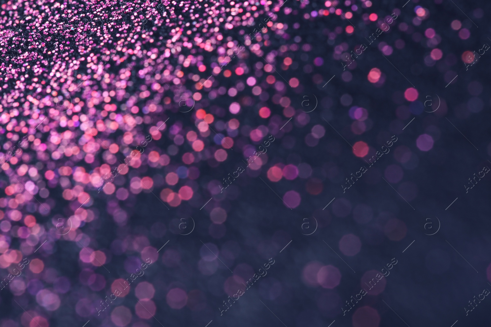 Photo of Pink glitter with bokeh effect on dark background