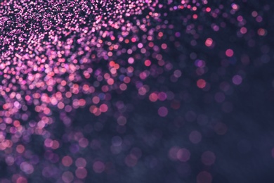 Pink glitter with bokeh effect on dark background