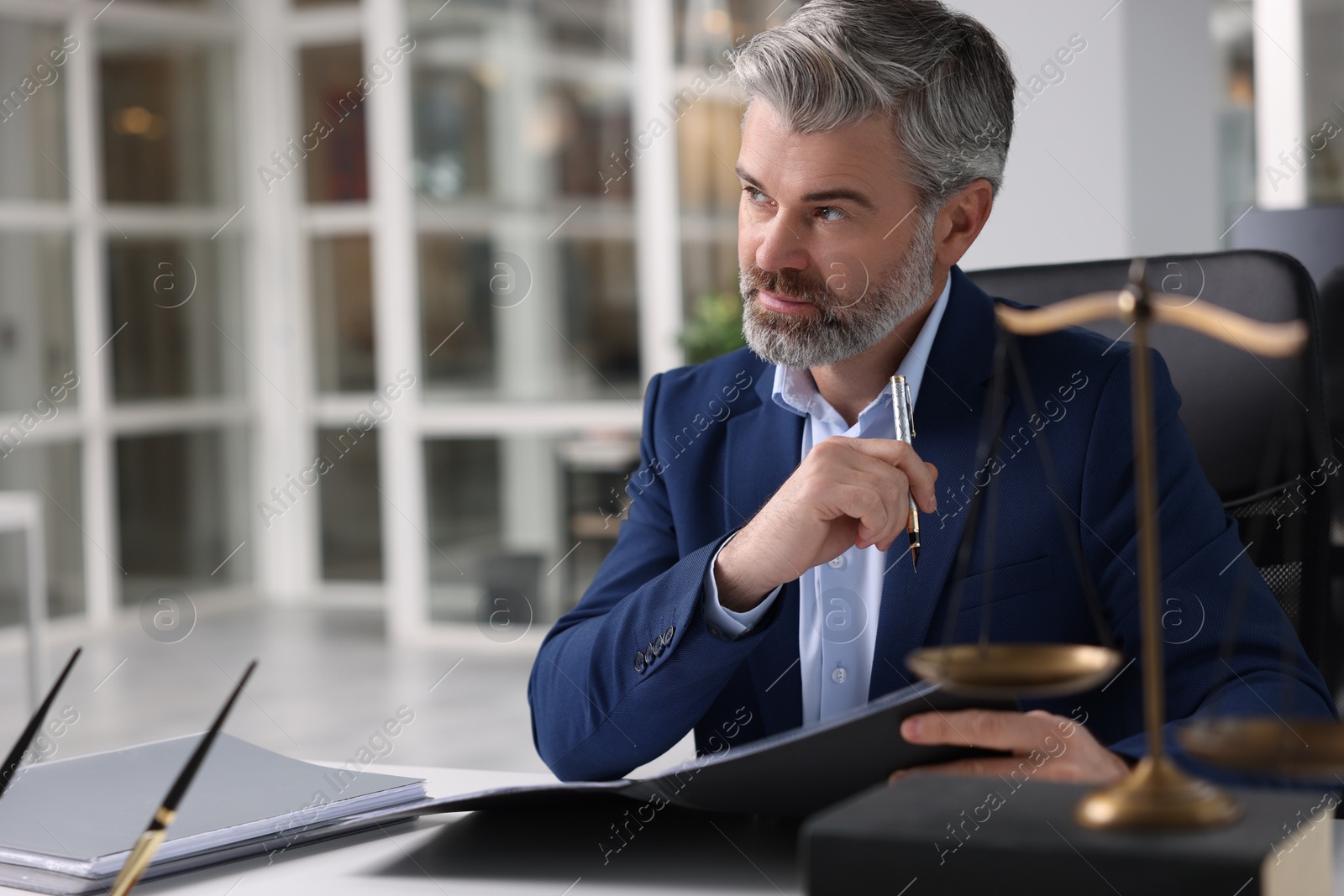 Photo of Portrait of handsome lawyer in office, space for text