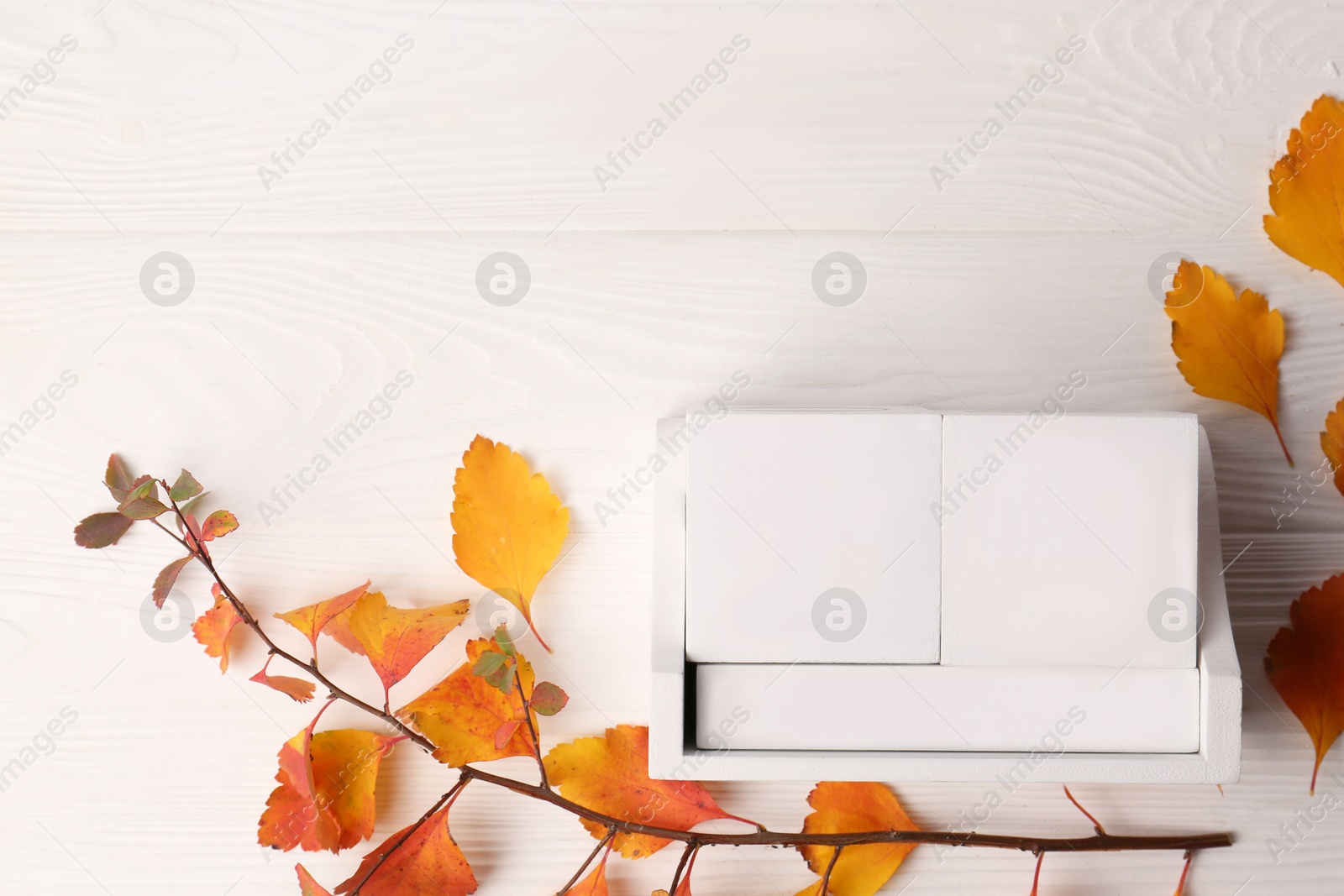 Photo of Thanksgiving day, holiday celebrated every fourth Thursday in November. Block calendar and branch with orange leaves on white wooden table, flat lay and space for text