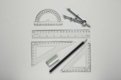 Photo of Flat lay composition with different rulers and compass on yellow background