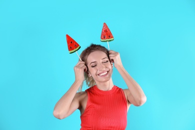 Photo of Young pretty woman with candies on colorful background