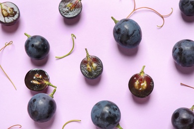 Photo of Flat lay composition with fresh ripe juicy grapes on lilac background