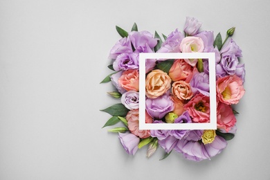 Photo of Flat lay composition with beautiful Eustoma flowers on grey background, space for text