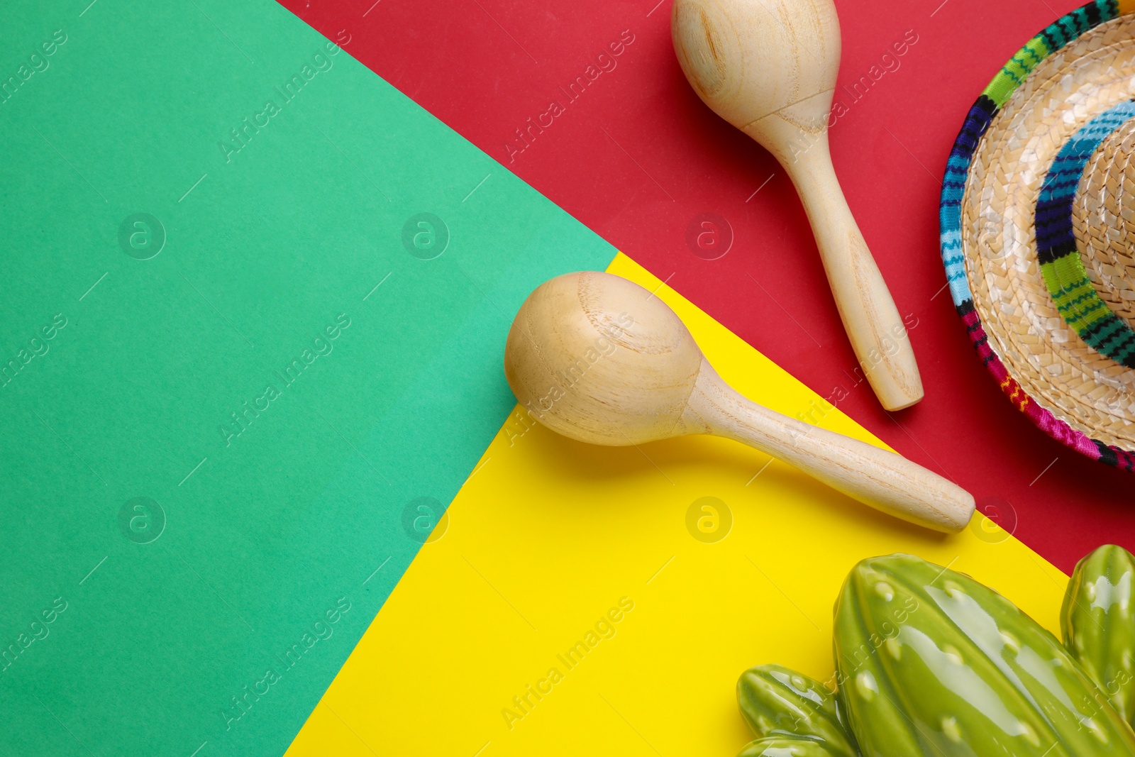 Photo of Maracas, toy cactus and sombrero hat on colorful background, flat lay with space for text. Musical instrument