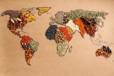 Photo of Paper with world map made of different aromatic spices as background, top view