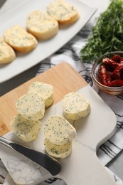 Photo of Tasty butter, dill, chili pepper and knife on table