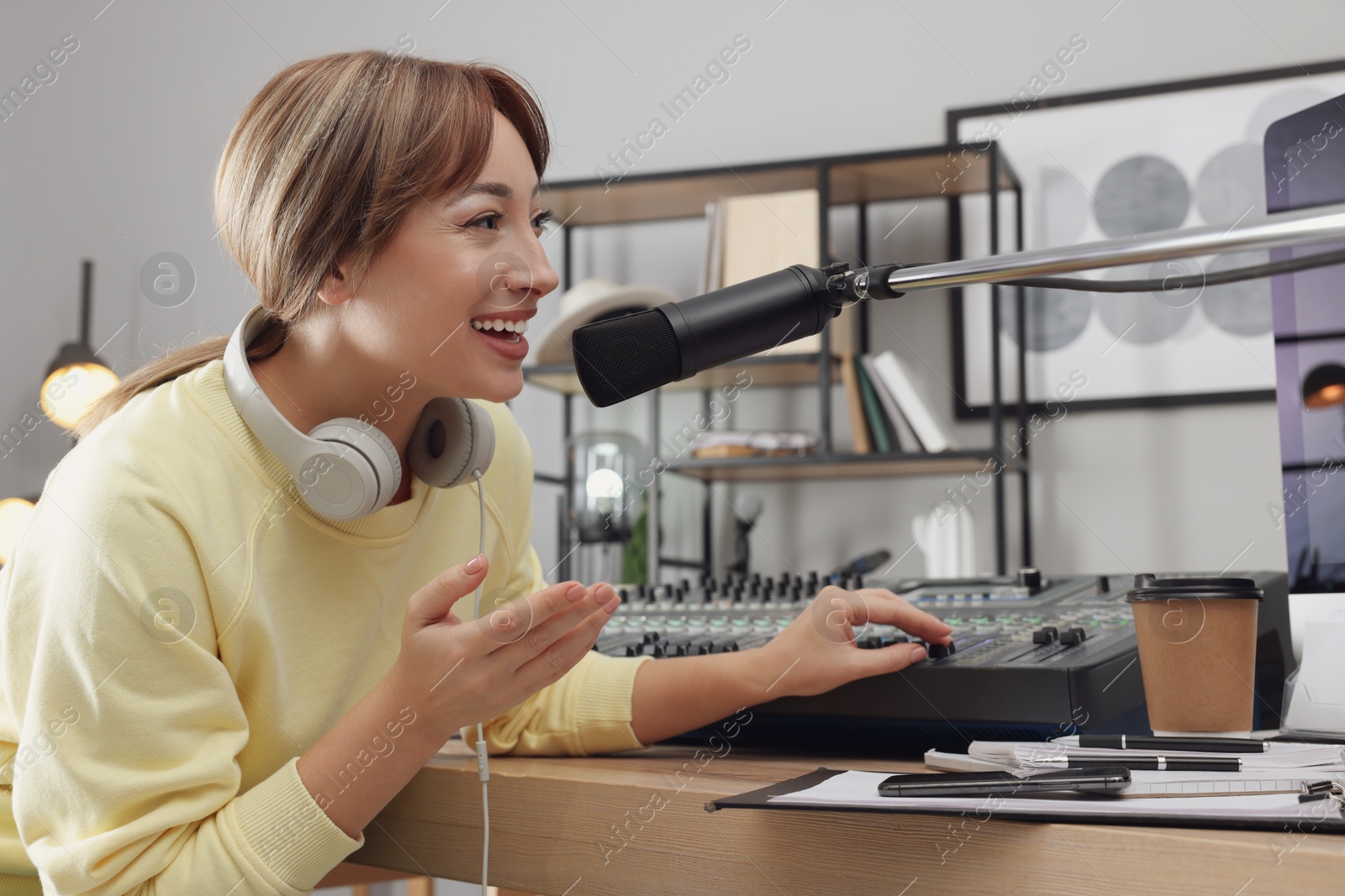 Photo of Woman working as radio host in modern studio