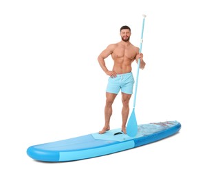 Happy man with paddle on blue SUP board against white background