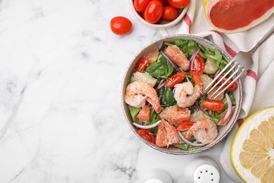 Delicious pomelo salad with shrimps served on white marble table, flat lay. Space for text
