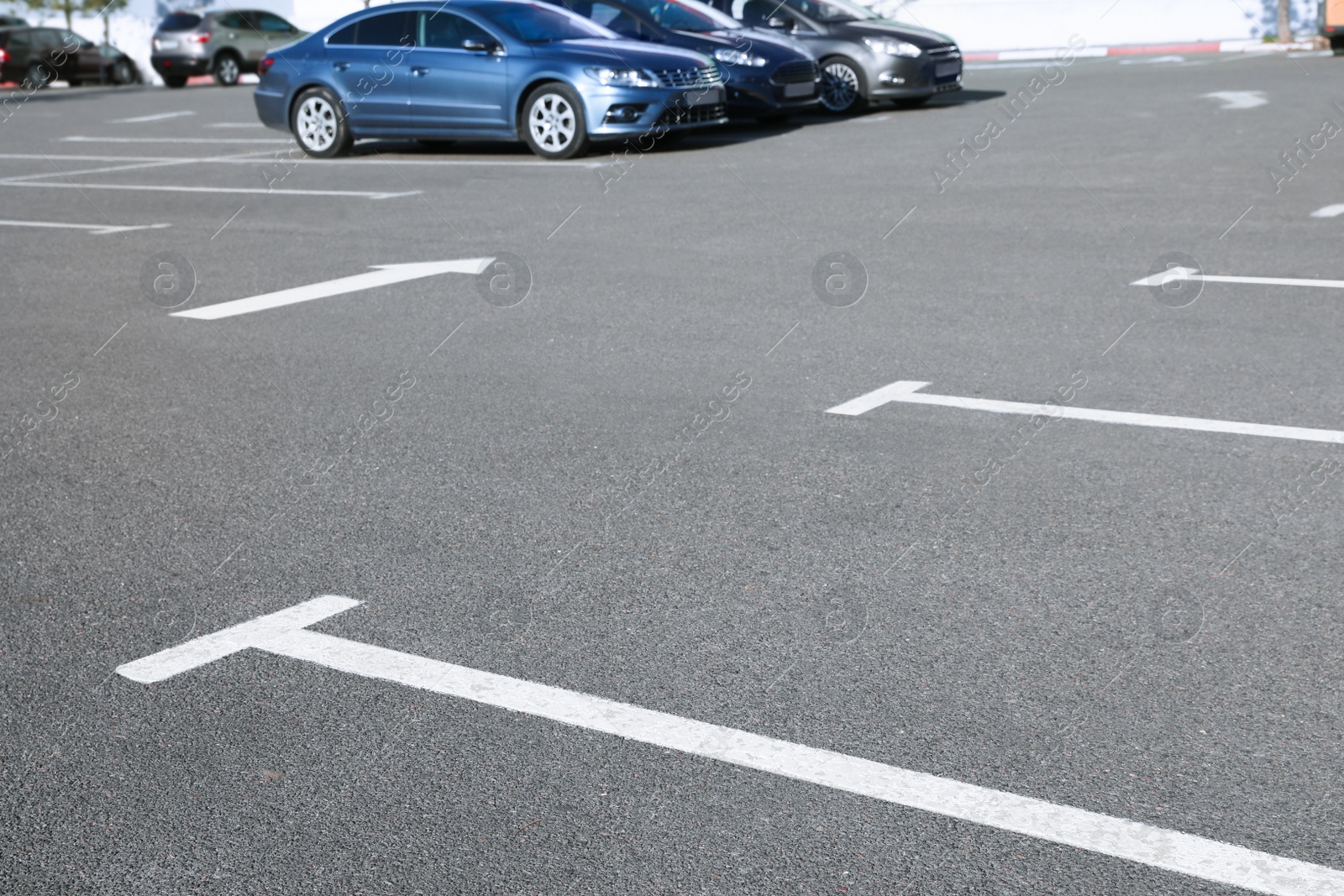 Photo of Car parking lot with white marking outdoors