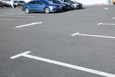 Photo of Car parking lot with white marking outdoors