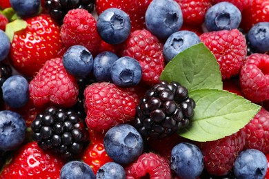 Photo of Different fresh ripe berries as background, closeup view