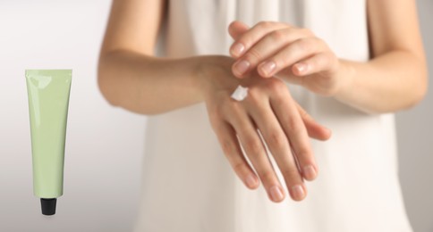 Image of Woman applying cream and tube of hand care cosmetic product on light background, closeup