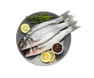 Photo of Plate with fresh sea bass fish, lemon and pepper on white background, top view