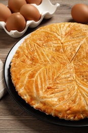 Photo of Traditional galette des rois on wooden table, closeup