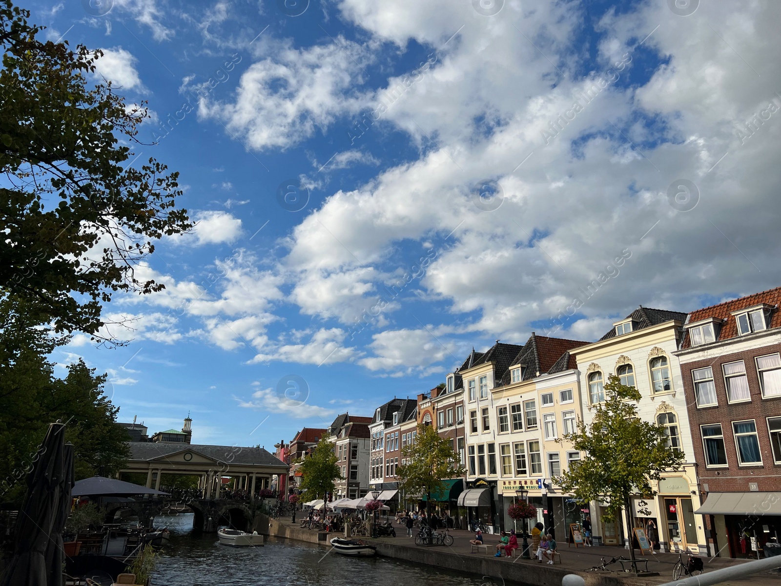 Photo of Beautiful view of buildings near canal in city under cloudy sky