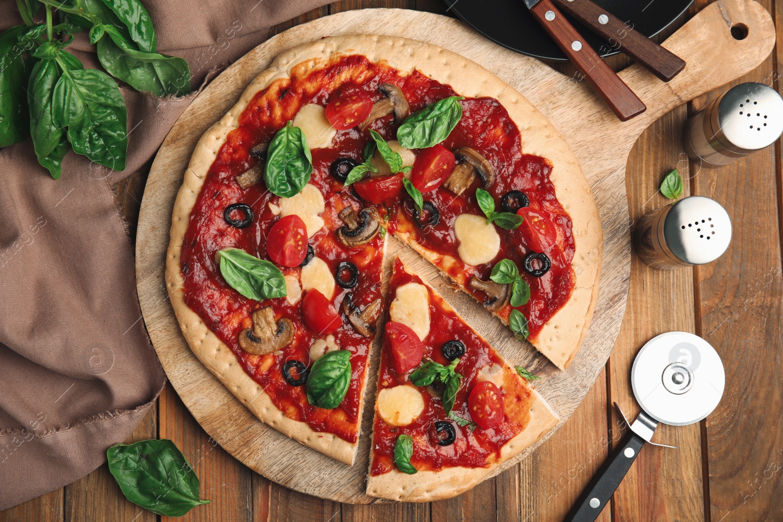 Photo of Delicious homemade pita pizza on wooden table, flat lay