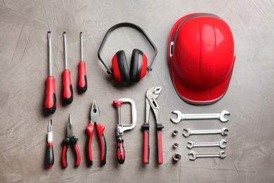 Photo of Flat lay composition with different construction tools on color background