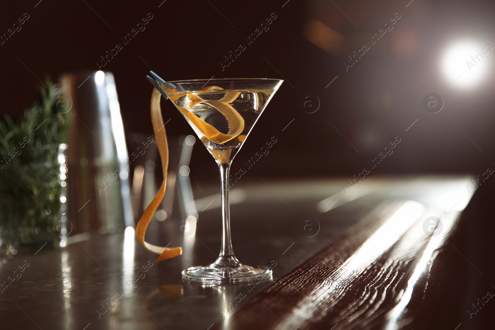 Photo of Glass of lemon drop martini cocktail on bar counter. Space for text