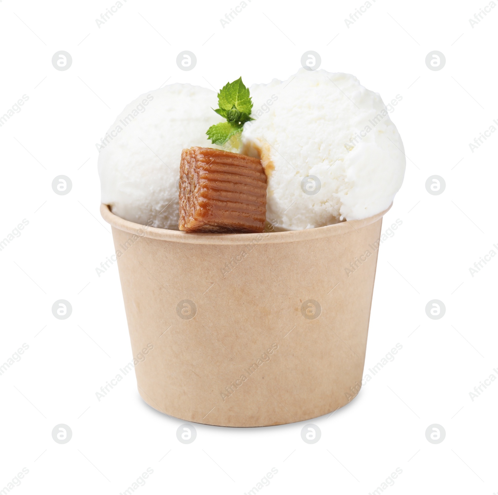 Photo of Scoops of tasty ice cream with mint leaves and caramel candy in paper cup isolated on white