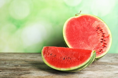 Photo of Fresh juicy watermelon with seeds on wooden table