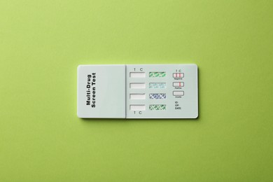 Multi-drug screen test on light green background, top view
