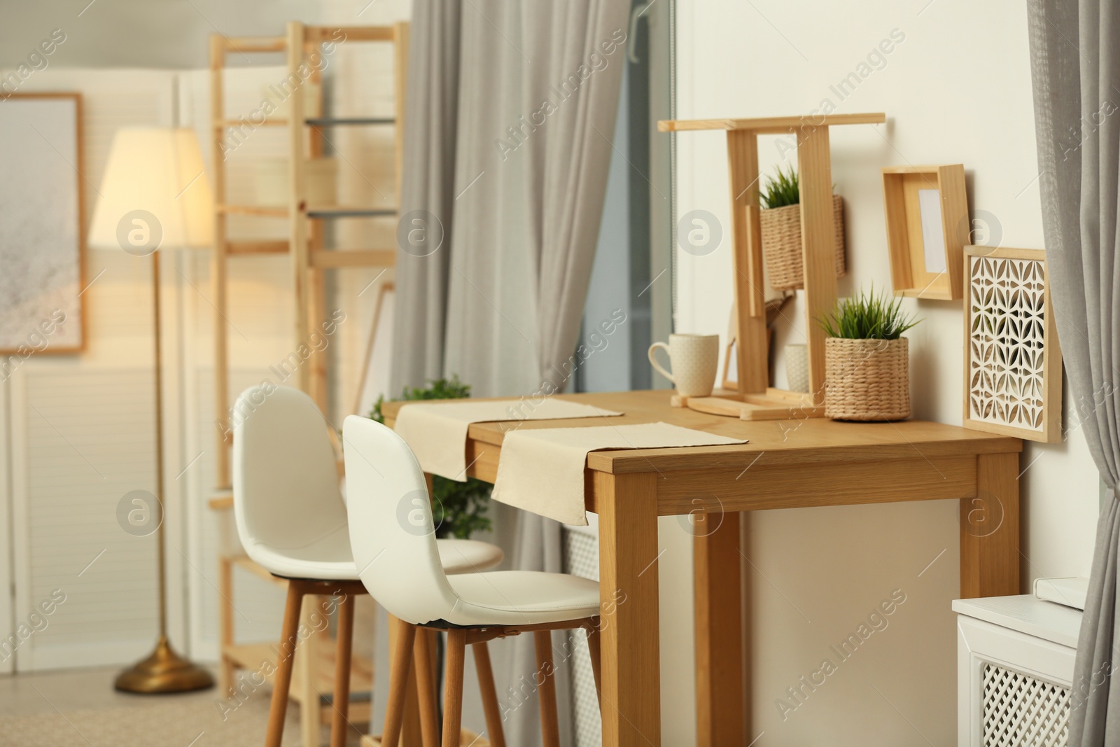 Photo of Modern room interior with wooden dining table. Space for text