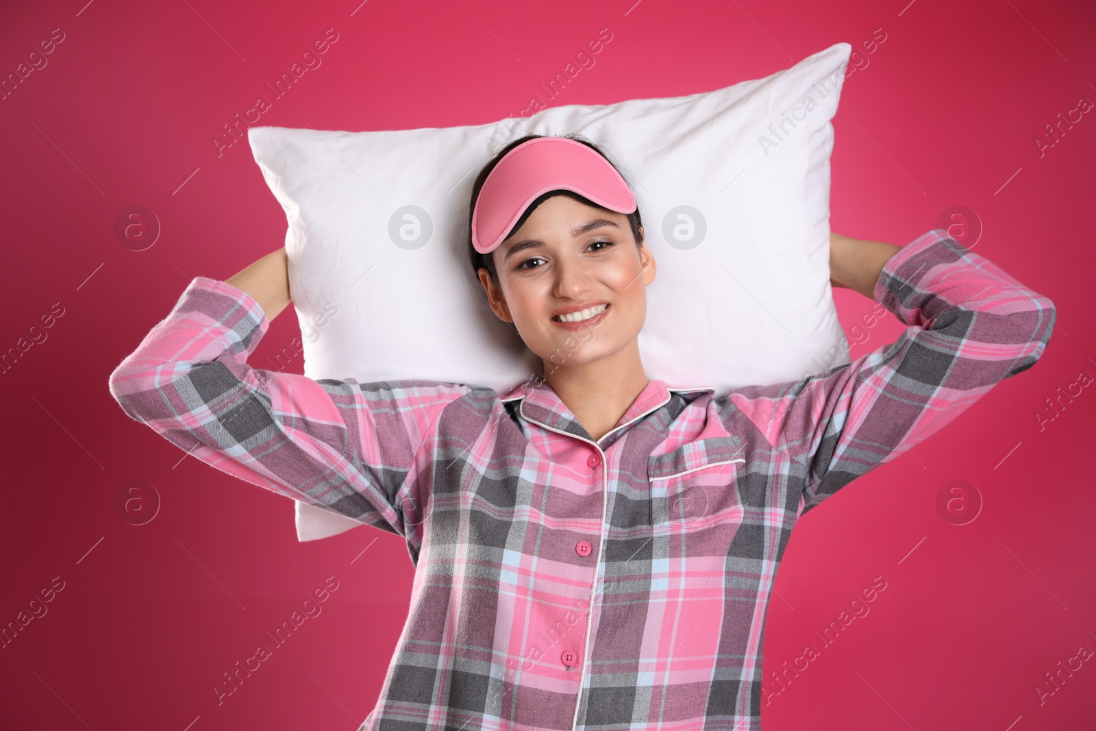 Photo of Beautiful woman with pillow on pink background. Bedtime