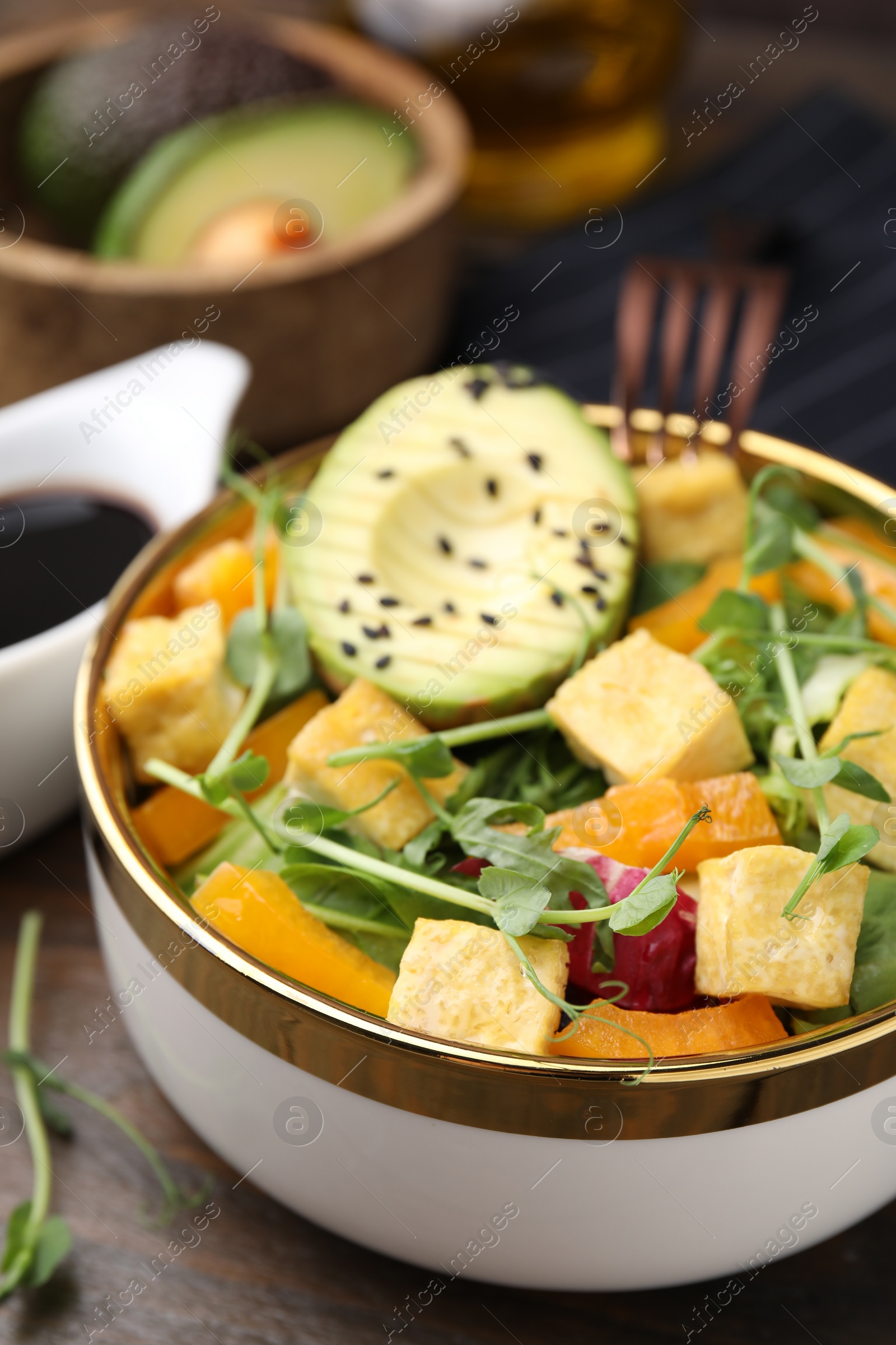 Photo of Delicious salad with tofu and vegetables on table, closeup
