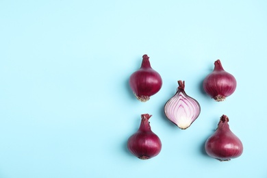 Beautiful composition with ripe red onions on color background