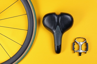 Set of different bicycle parts on color background, flat lay