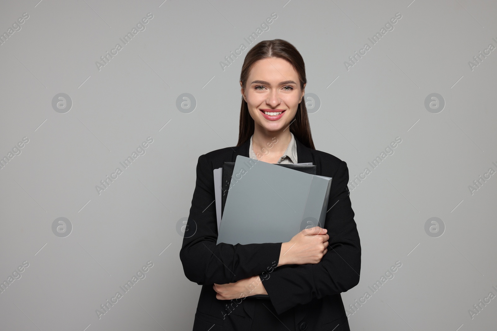 Photo of Portrait of beautiful young teacher on grey background